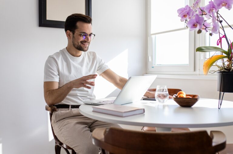 Man working at home using laptop.